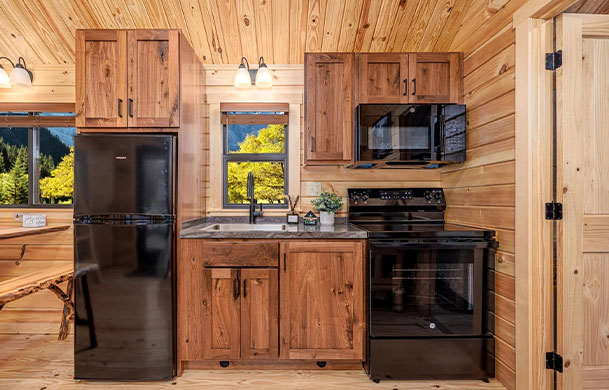 Premium Lodge cabin queen bedroom at Adventure Bound Tall Pines